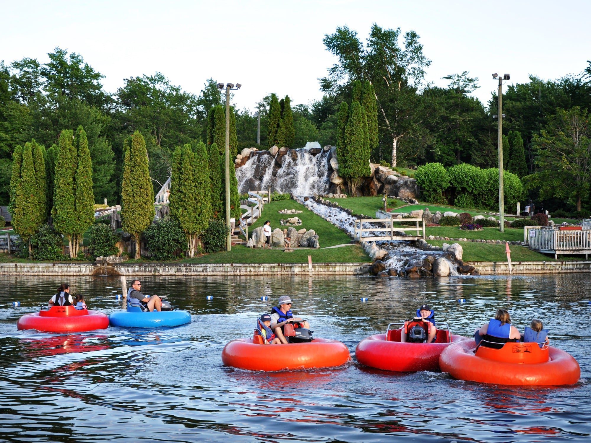 An image of bumper boats in a small pond. 