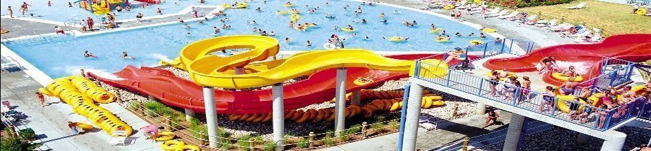 An image of water slides into a large pool.