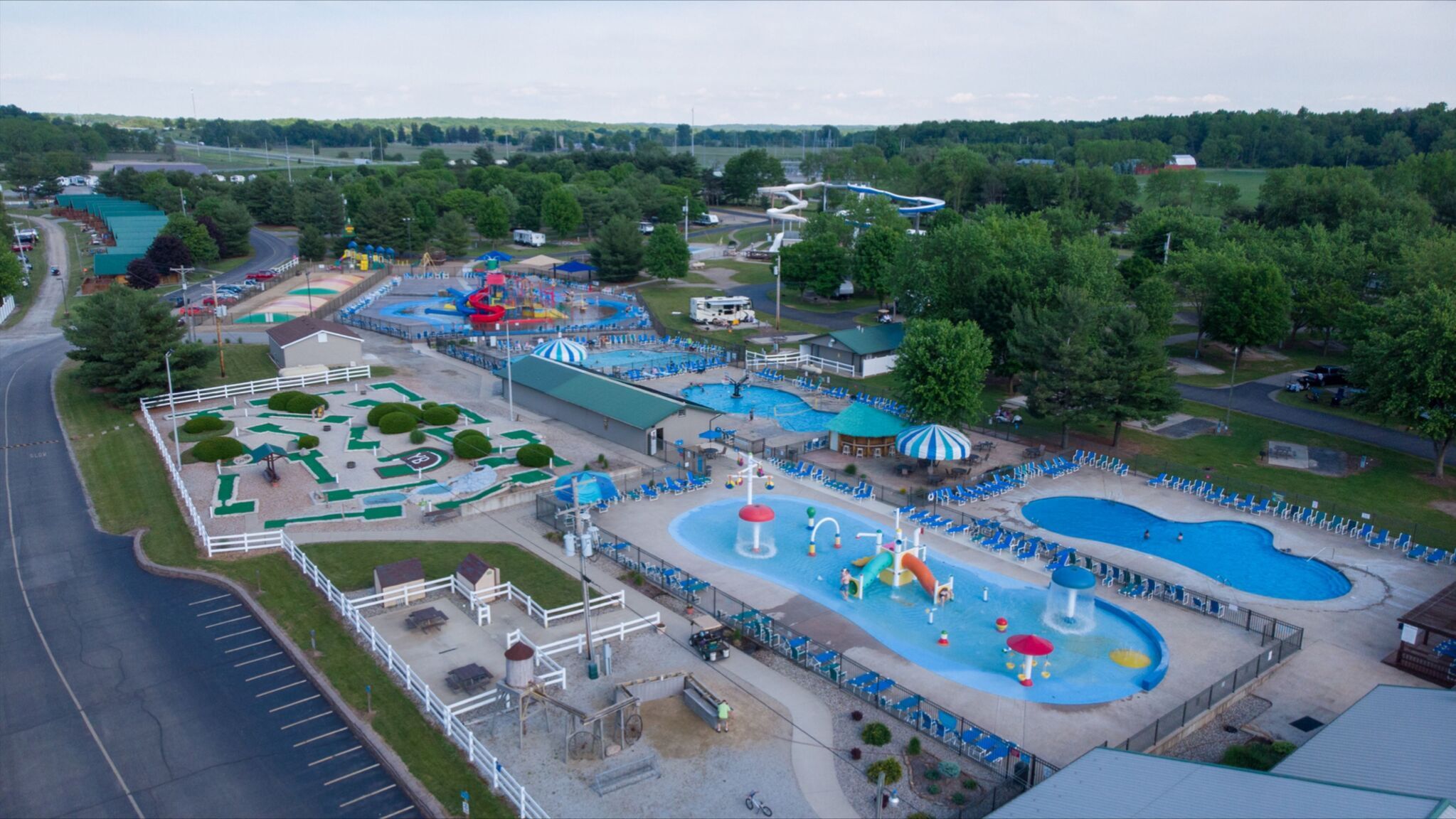 An image of pools, putt putt golf and bouncing pillows at Jellystone Park. 